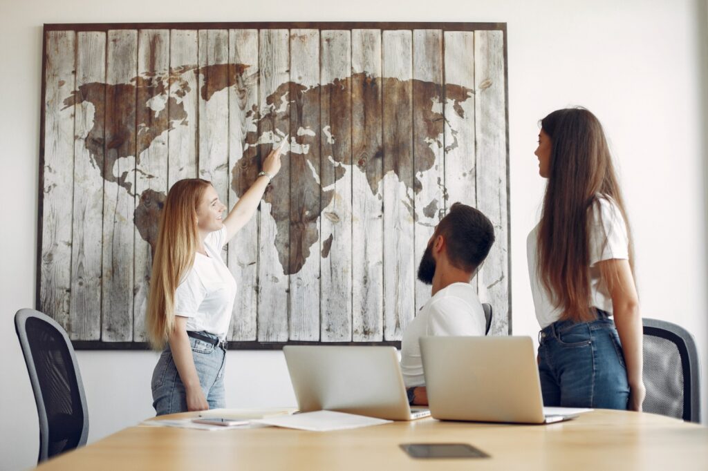 A person pointing Europe on the world map