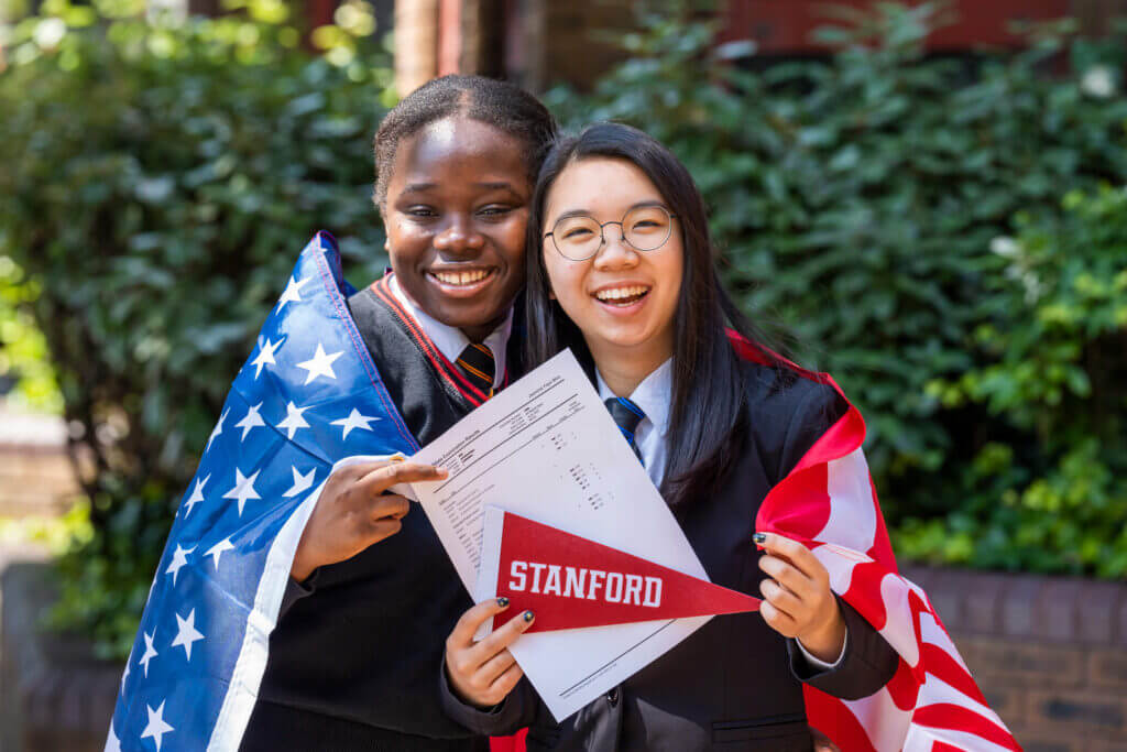 International students holding admission letters from Stanford University.